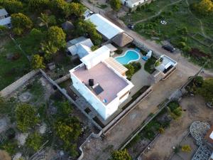 an overhead view of a white house with a swimming pool at Villa Verona Watamu in Watamu