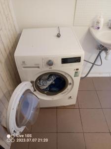 a washing machine in a bathroom next to a sink at Zielony Port numer 2 in Władysławowo