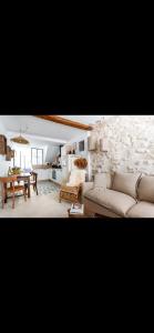 a living room with a couch and a table at Intramuros Avignon House in Avignon