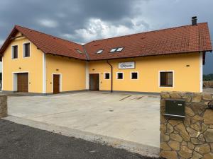 a large yellow building with a parking lot at Penzion 666 Slavonice in Slavonice
