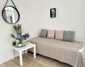 a room with a couch and a table with a mirror at Marta in Stresa