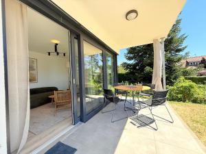 a patio with a table and chairs on it at Suite Carpe Diem in Uhldingen-Mühlhofen