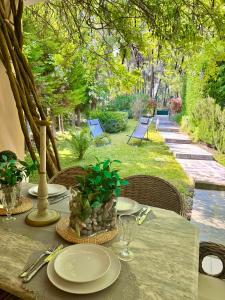a table with plates and a plant on it at Sani Nature Retreat - Elegant Stay by Forest and Sea in Sani Beach