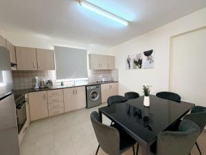 a kitchen with a dining room table and chairs at Sunrise Palette Suites in Larnaca