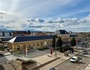 a large yellow building in a city with a street at Face à la gare - Chambre 4 in Roanne +3 photos