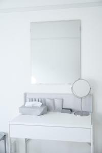 a white room with a white bed with a lamp at SETO8 House in Seto