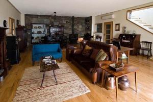 a living room with a couch and a table at Phenomenal Pinhao Villa 3 Bedrooms Villa Douroco Beautiful Valley Views Pool Table in Pinhão