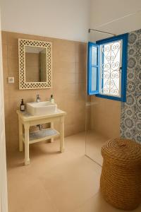 a bathroom with a sink and a mirror and a window at Dar El Aalia Sea View Stay in Iconic Sidi Bou Saïd in Sidi Bou Saïd +6 photos