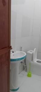a bathroom with a sink and a toilet at Maga Apartment in Kinyasini +1 photo