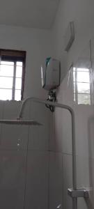 a bathroom with a shower and a mirror on the wall at Maga Apartment in Kinyasini
