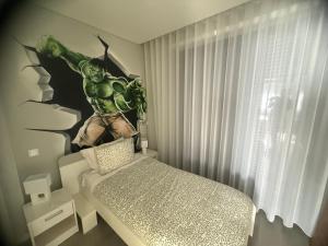 a bedroom with a hulk mural on the wall at Villaparaiba in São Mamede de Infesta