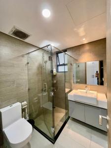 a bathroom with a toilet and a sink and a shower at Apartment Alnata Diamond 2 Bedrooms Celadon City in Kon Rung (1) +23 photos