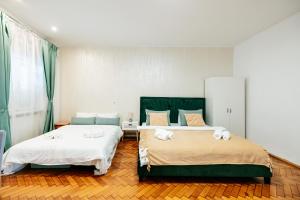 En eller flere senge i et værelse på The Muse - Kronstadt Central Suites