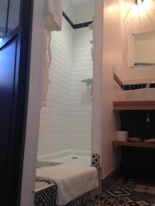 La salle de bains est pourvue d'une douche et d'une baignoire. dans l'établissement Les Jardins De Galicia, à Sète