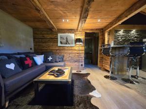 a living room with a couch and a table at Le Mazot in Megève
