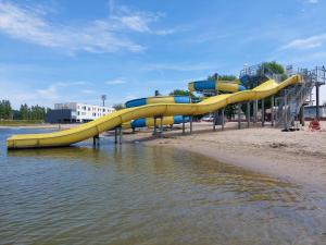 a slide in the water at a water park at Vakantiepark Klein Strand - Comfort Chalet 6p in Jabbeke