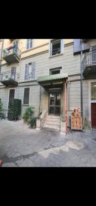 a building with a door and a table in front of it at Lilly Home in Milan