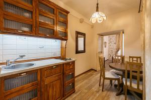 a kitchen with a sink and a table and a dining room at Apartments Leo in Kotor +50 photos