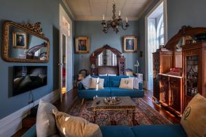 a living room with a blue couch and a table at Quinta das Penas Cerveira in Vila Nova de Cerveira