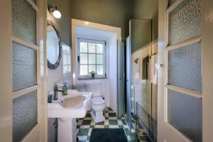 a bathroom with a sink and a toilet and a window at Quinta das Penas Cerveira in Vila Nova de Cerveira +51 photos