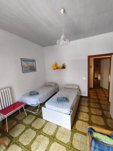 a room with two beds and a chair in it at Casa Vinella in Putignano +15 photos