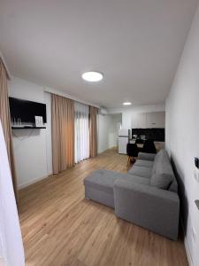 a living room with a couch and a table at Villa Fibonacci - Beachfront Lalez Bay Durres in Draç