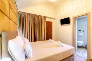 a bedroom with a bed with two towels on it at Fantastic Seafront Villa 4 Bedrooms Villa Samostan Prestige Stunning Sea Views & Enclosed Garden With Private Pool Korcula in Korčula +32 photos