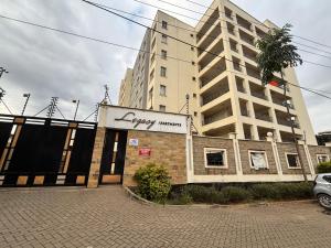 a building with a sign that reads happy memory at Lina Apartment in Nairobi