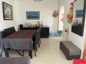 a dining room with a table and some chairs at APPART SARAH Plage in Hammamet Nord