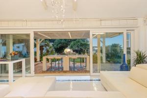 an open living room with a table in a house at Villa Ambra 10, Emma Villas in Sorso