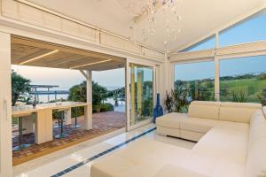 a living room with a couch and a table at Villa Ambra 10, Emma Villas in Sorso