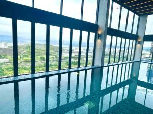a swimming pool in the middle of a building with windows at Green Zone - San Tower Dragon Castle in Ha Long