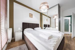 a bedroom with two large beds and a large mirror at Comfort Apartments Batorego in Gdynia
