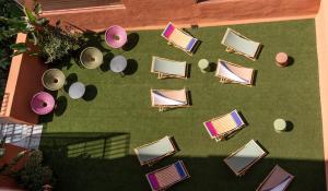 an overhead view of chairs and tables on a lawn at htop BCN - City in Barcelona
