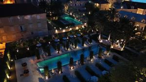 an overhead view of a hotel pool at night at Aura Maris Sutivan in Sutivan