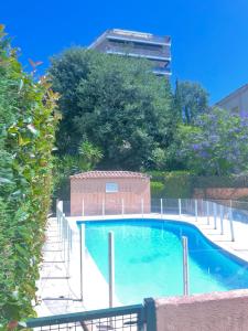 a swimming pool with a fence around it at Prince de Galles in Cannes