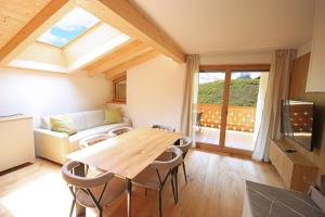 a living room with a table and a couch at Aurturist Sesto in Sesto