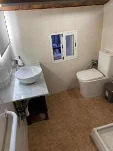 a bathroom with a sink and a toilet at Casita esquiladores in Cuenca