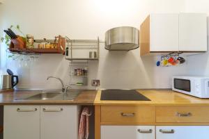 a kitchen with a sink and a microwave at Casa Alderotti in Bologna