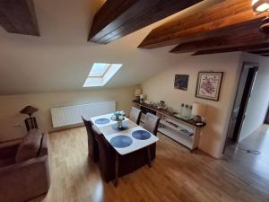 a living room with a table and a couch at Vila De la Lugas in Oradea
