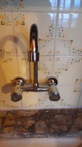 a bathroom sink with aaucet on a tiled wall at Residencia "Libertad " in San Andrés +10 photos
