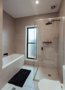 BooragulにあるBright & Modern Booragul Home for Familiesのシャワー、浴槽、洗面台を備えたバスルーム +41枚の写真