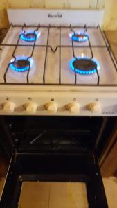 a white stove top oven with blue lights on it at Residencia "Libertad " in San Andrés