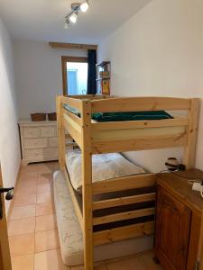 a bedroom with two bunk beds in a room at Charme assuré in Crans-Montana