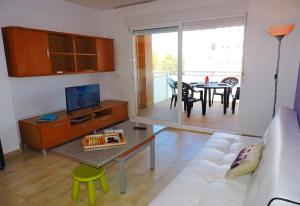 a living room with a couch and a table at Lcd - Maricel in Miami Platja