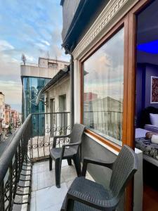 a balcony with two chairs and a window at Mitra Downtown Hotel in Istanbul