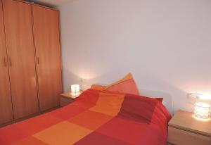a bedroom with a multicolored bed and a cabinet at Lcd - Maricel in Miami Platja +13 photos