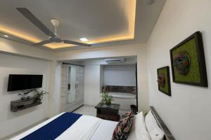 a bedroom with a bed and a flat screen tv at Hotel Park Inn in Mumbai