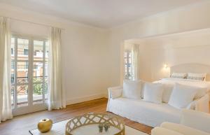 a white bedroom with a bed and a couch at Etoile Luxury Suites in Argostoli