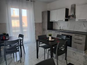 a kitchen and dining room with two tables and chairs at LaVenere da Gigi e Patty in San Salvo